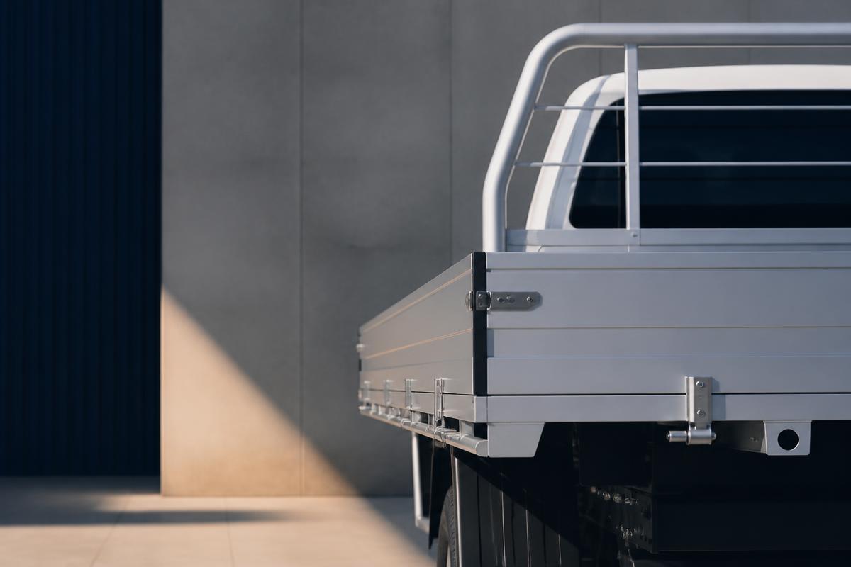 Clean utility vehicle tray in soft daylight against a minimal architectural wall